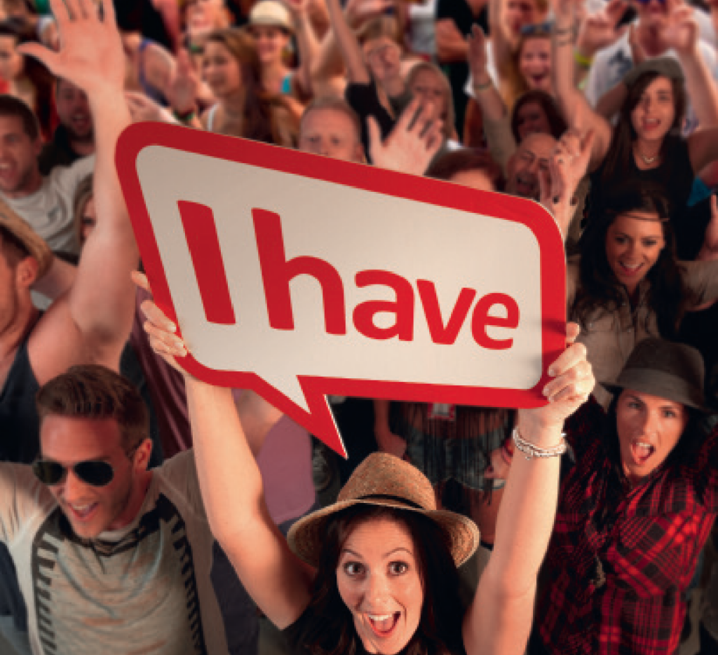 Crowd cheering with a sign that says ‘I have.’