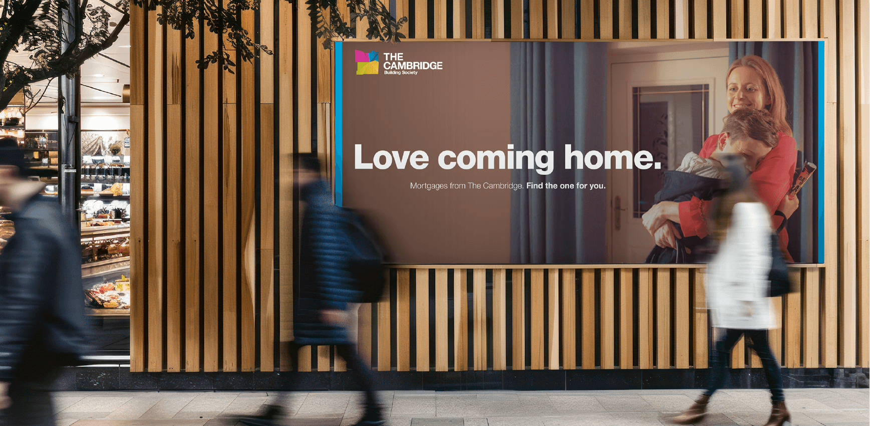 Street level advertising board with a mortgage ad from the Cambridge Building Society titled "Love coming home.