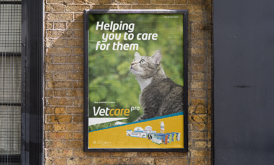 poster on a brick wall featuring a cat and advertising Vetcare Pro pet products.