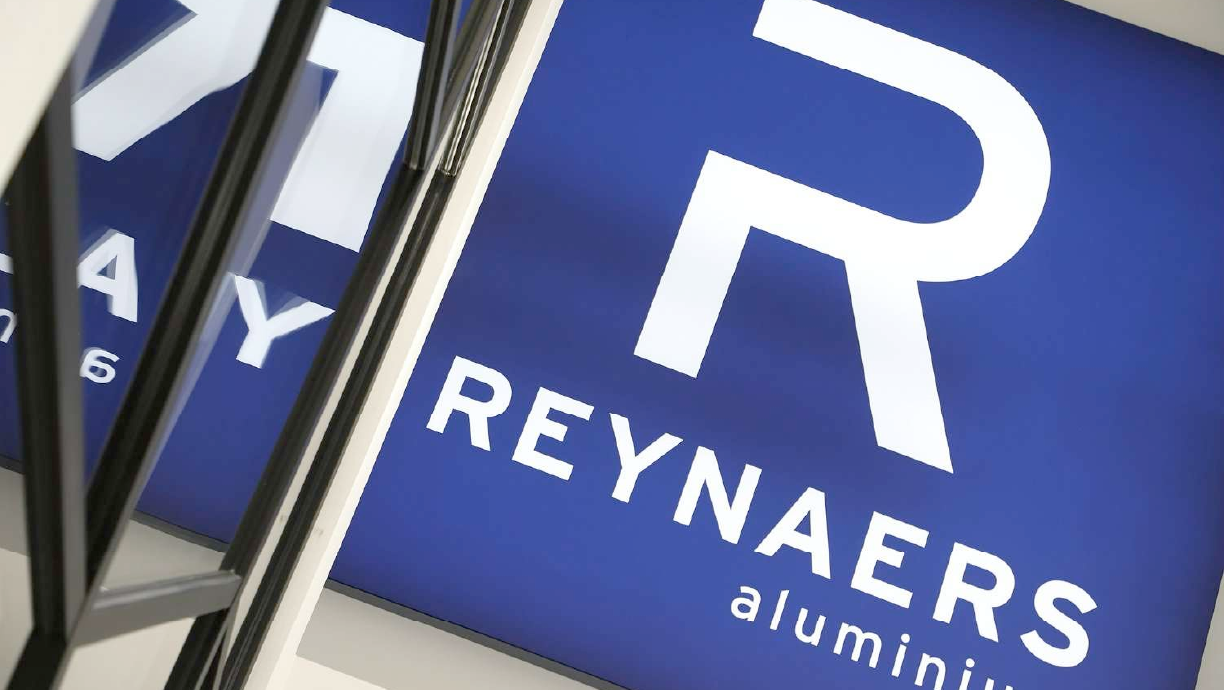 Photo of a Reynaers logo sign in situ.