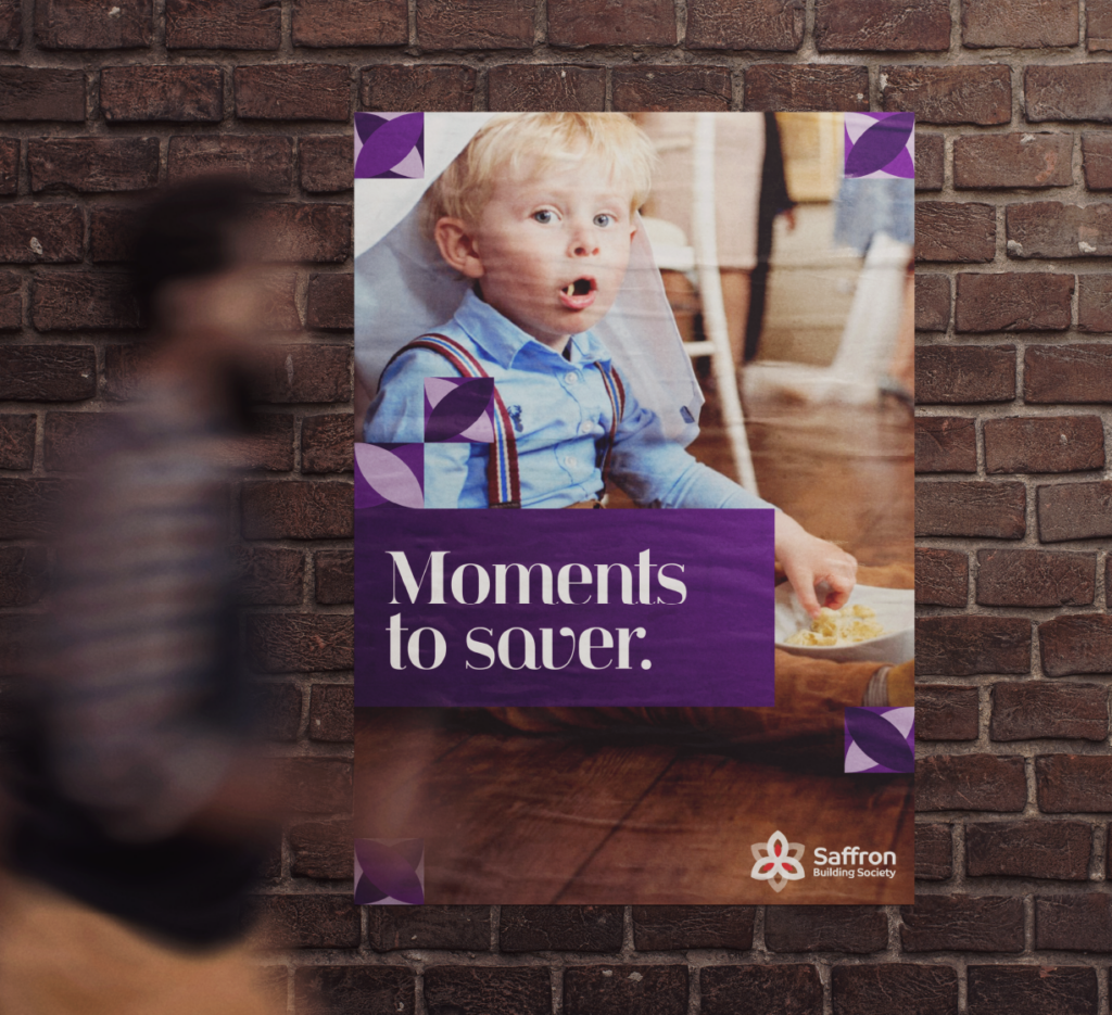 “Poster on a brick wall advertising Saffron Building Society with the message ‘Moments to saver.