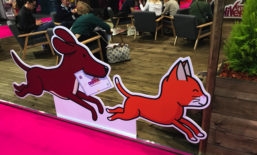 Cartoon dog and cat display at an indoor event space.