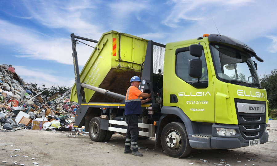 Ellgia truck collecting waste at a recycling site.