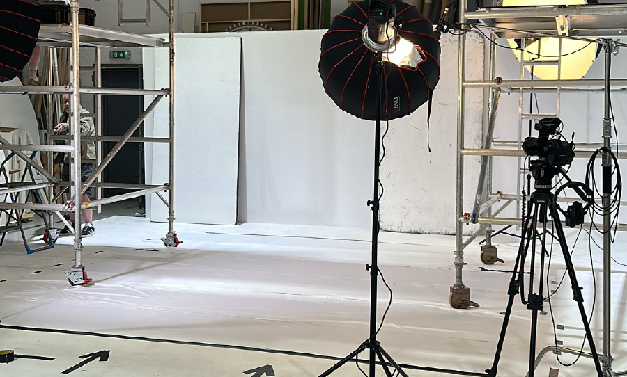 Photography studio setup with lighting, camera, and backdrop.